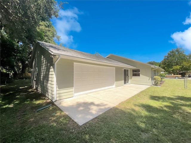 view of front of home with a garage and a front lawn