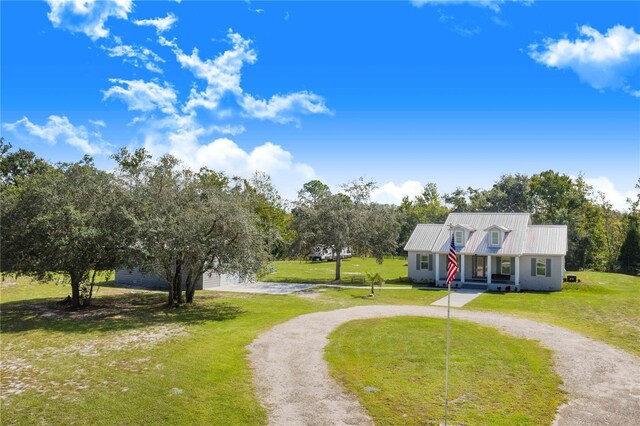 view of front of property with covered porch and a front yard