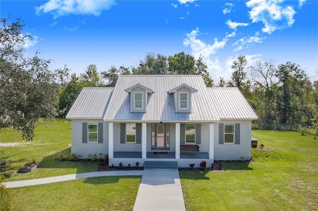 cape cod house with a front yard and covered porch