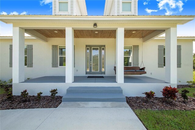 view of exterior entry with a porch