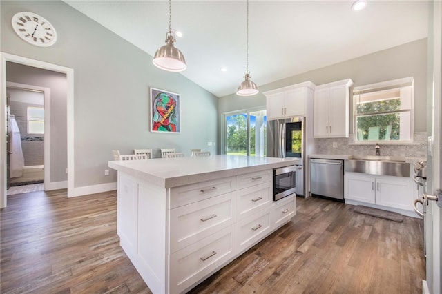 kitchen with sink, white cabinetry, dishwasher, lofted ceiling, and tasteful backsplash