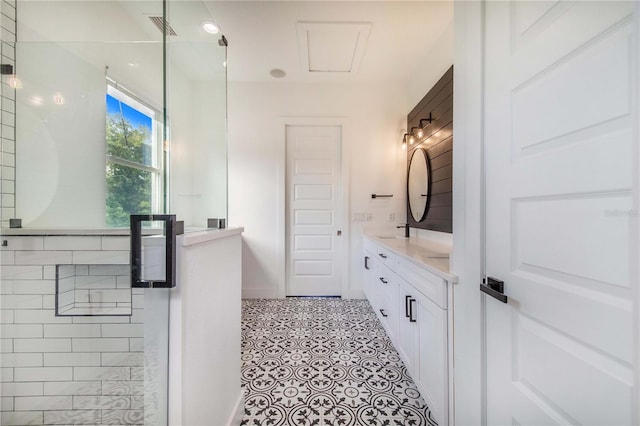 bathroom with tile patterned floors, vanity, and a shower with shower door