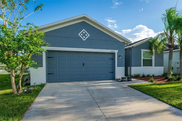 view of front of home featuring a garage and a front lawn