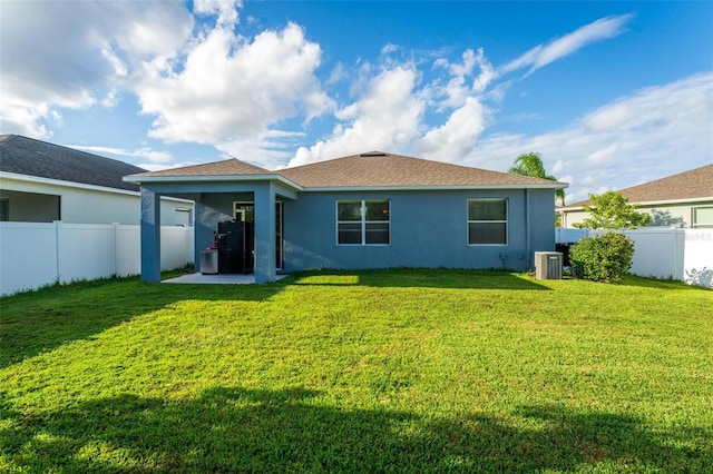 back of property with a lawn, a patio, and central air condition unit