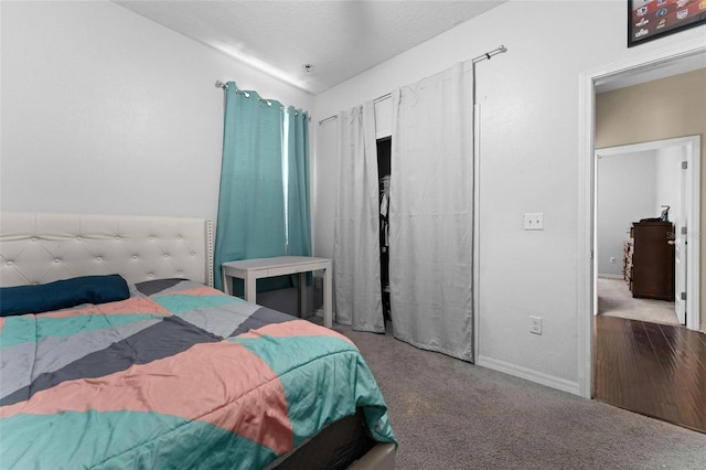 bedroom featuring a textured ceiling and carpet flooring