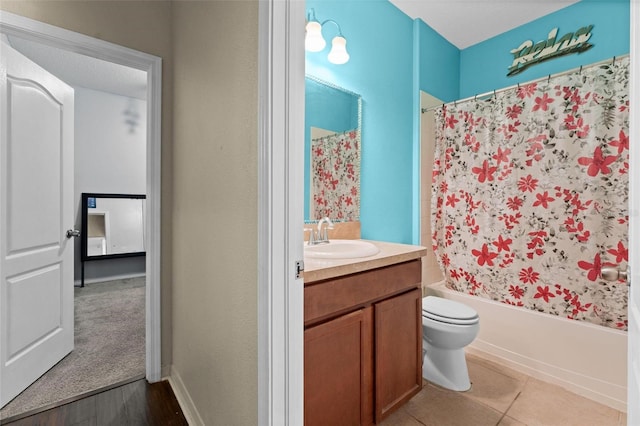 full bathroom featuring shower / bath combo, hardwood / wood-style floors, vanity, and toilet