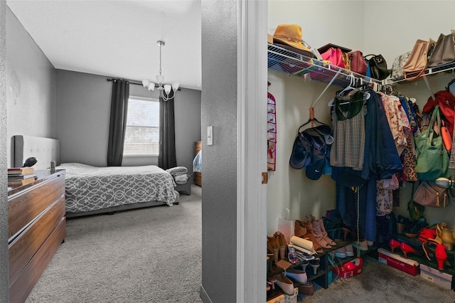 carpeted bedroom featuring a notable chandelier