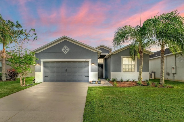 single story home with a yard and a garage