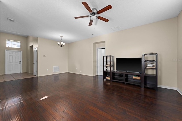 living room with a textured ceiling, ceiling fan with notable chandelier, and dark hardwood / wood-style floors