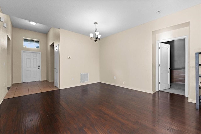 interior space with an inviting chandelier and dark hardwood / wood-style floors