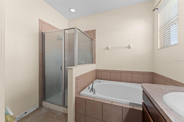 bathroom with plus walk in shower, tile patterned flooring, and vanity