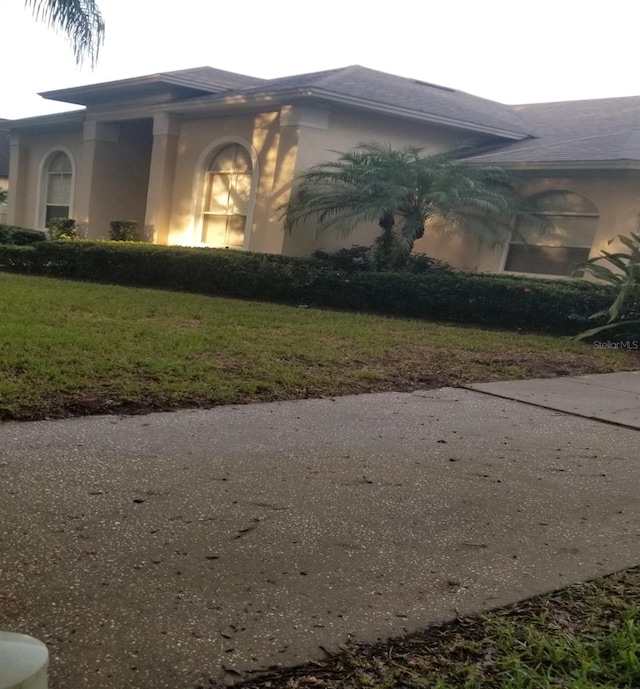 view of side of home featuring a yard