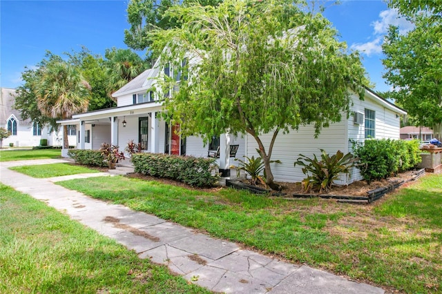 view of front of property with a front yard and covered porch