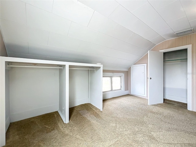 bonus room featuring vaulted ceiling and carpet floors