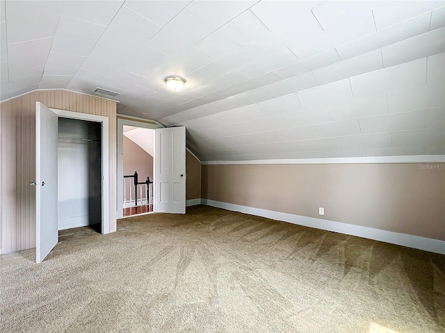 additional living space featuring lofted ceiling and carpet floors