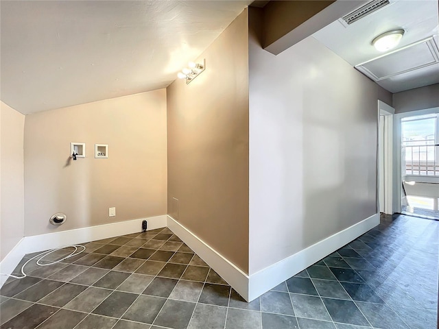 laundry area featuring washer hookup and dark tile patterned floors