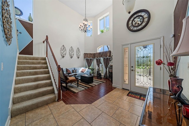 entryway featuring a high ceiling, a notable chandelier, and light hardwood / wood-style flooring