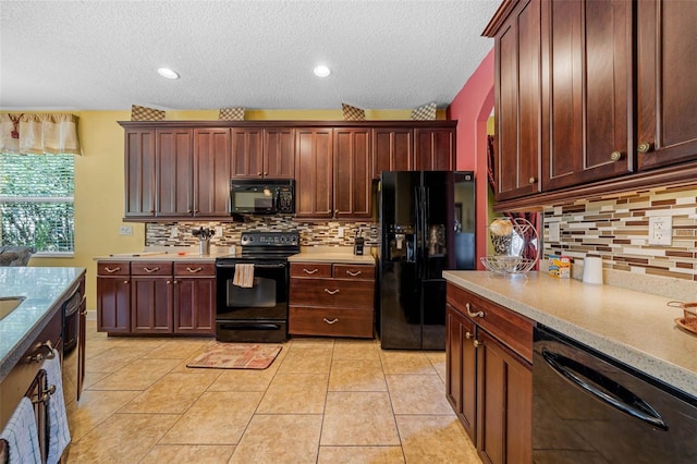 kitchen with black appliances, light tile patterned floors, tasteful backsplash, and a textured ceiling