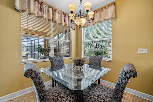 dining area featuring an inviting chandelier and tile patterned flooring