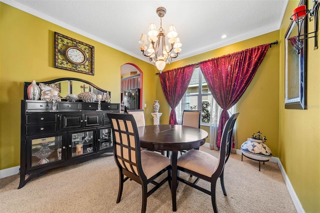 carpeted dining space featuring crown molding, a notable chandelier, and a textured ceiling