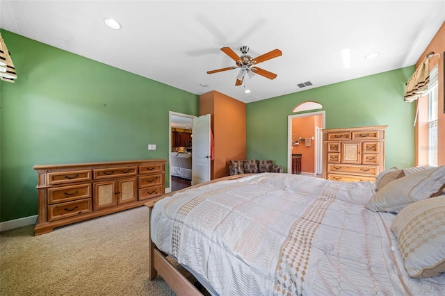 carpeted bedroom featuring ensuite bathroom and ceiling fan