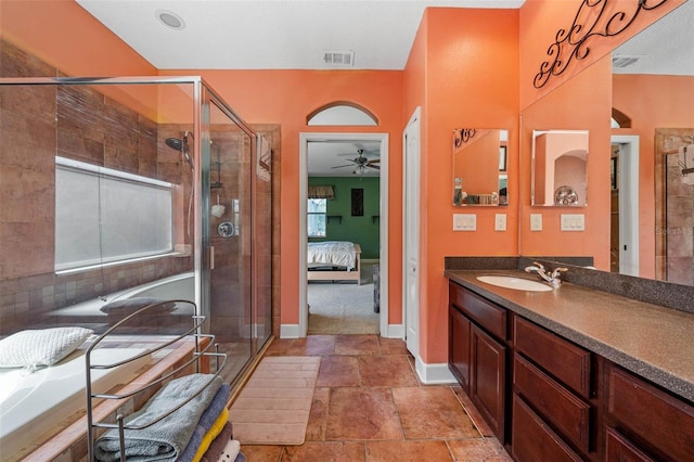 bathroom featuring vanity, a shower with shower door, and ceiling fan