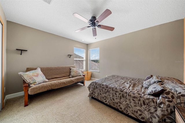 carpeted bedroom with a textured ceiling and ceiling fan