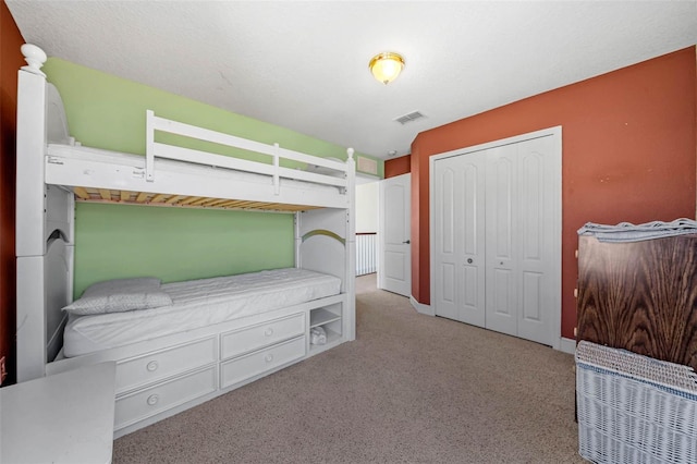 carpeted bedroom featuring a closet