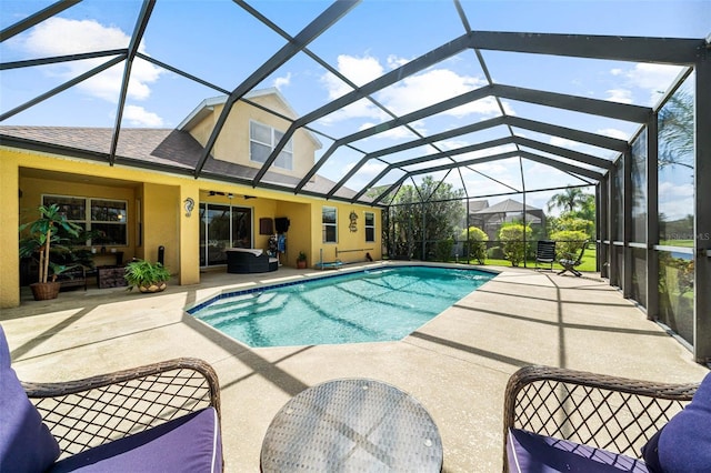 view of swimming pool featuring a lanai and a patio