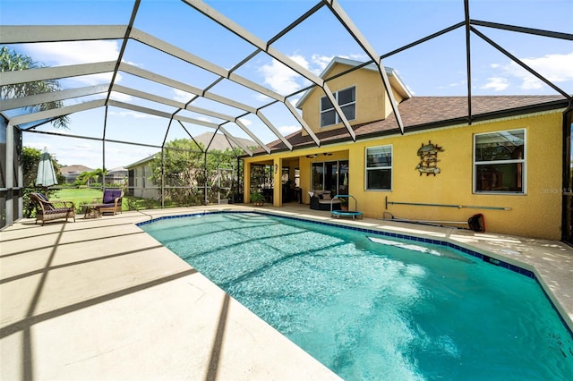 view of swimming pool featuring a lanai and a patio