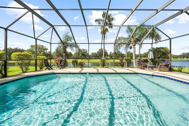 view of swimming pool featuring a water view, a patio, and a lanai