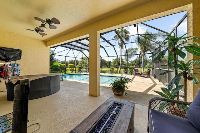 view of swimming pool featuring a lanai, ceiling fan, and a patio