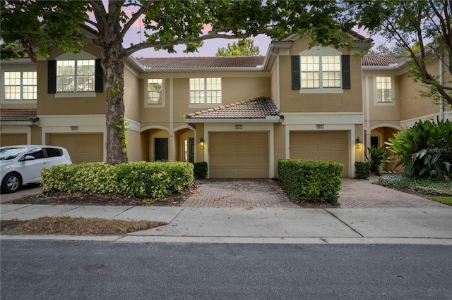 townhome / multi-family property featuring a garage