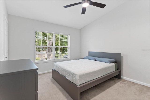 bedroom featuring lofted ceiling, light colored carpet, and ceiling fan