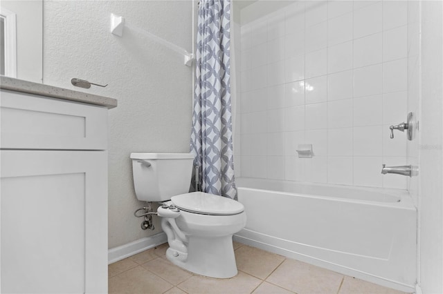 bathroom featuring shower / bath combo with shower curtain, toilet, and tile patterned floors