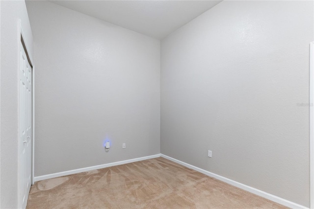 carpeted spare room with lofted ceiling