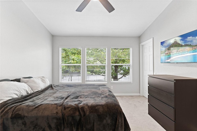 carpeted bedroom with lofted ceiling, multiple windows, and ceiling fan