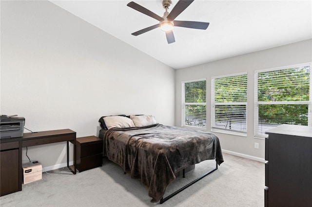 bedroom with lofted ceiling, ceiling fan, and light carpet