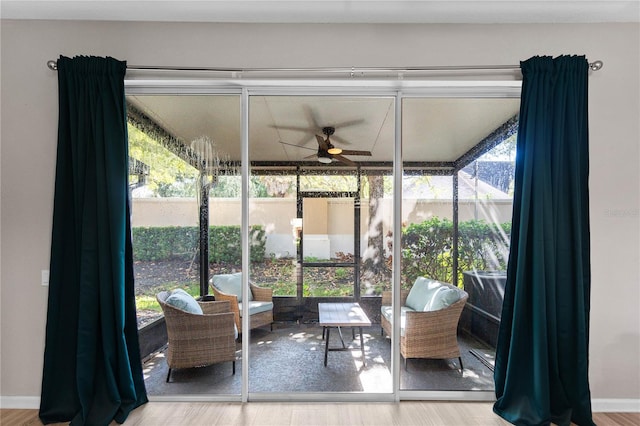 sunroom with a healthy amount of sunlight and ceiling fan