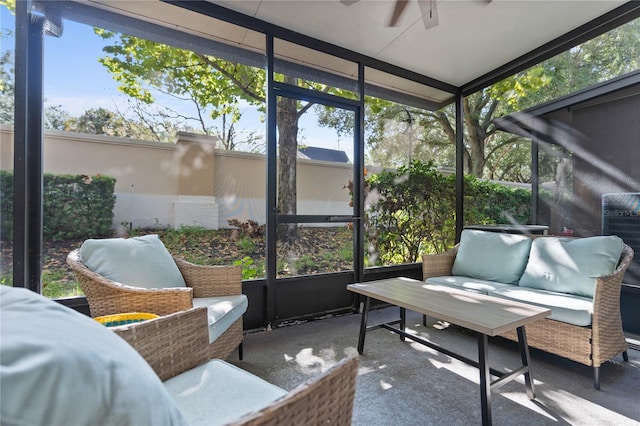 sunroom / solarium featuring a healthy amount of sunlight and ceiling fan