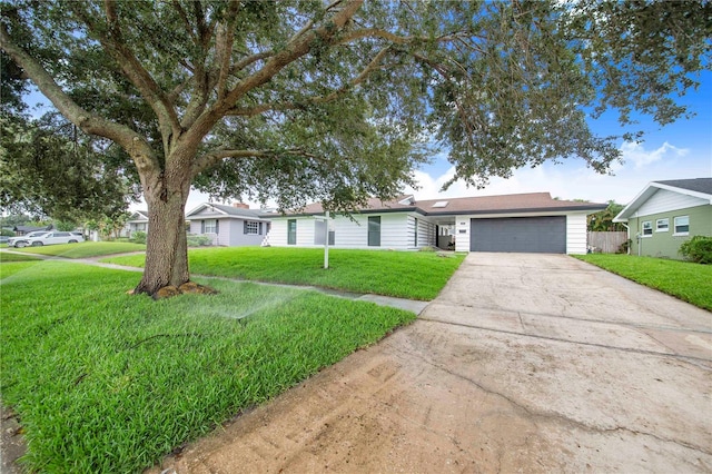 single story home featuring a front lawn and a garage