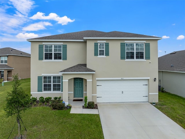 view of front property with a garage and a front lawn