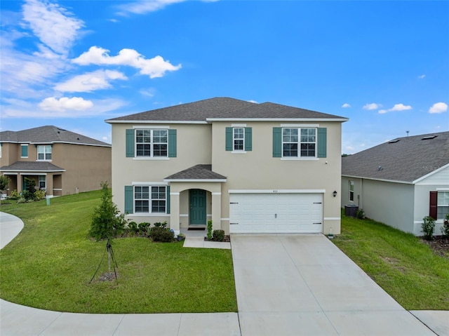 front of property with a front lawn, a garage, and central AC unit