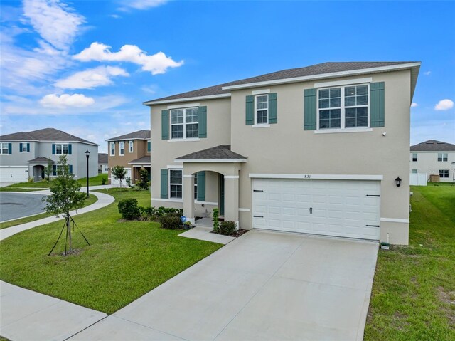 view of front of property with a garage and a front lawn