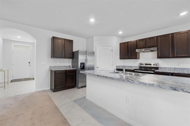 kitchen featuring appliances with stainless steel finishes, sink, light tile patterned flooring, and dark brown cabinetry