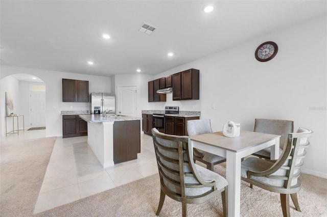 carpeted dining room with sink