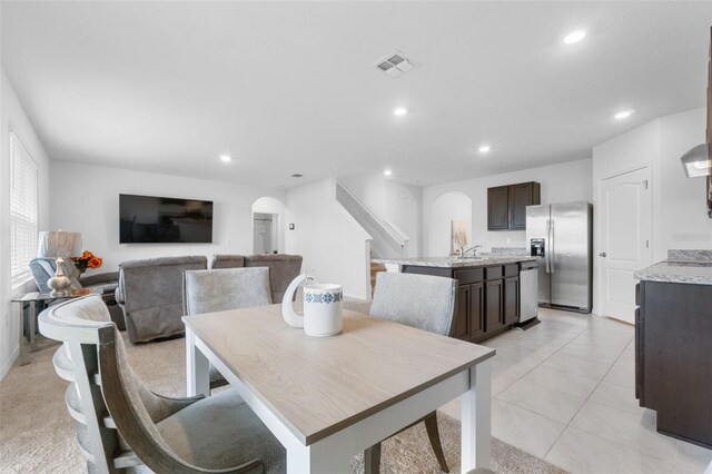 dining room with light tile patterned floors and sink