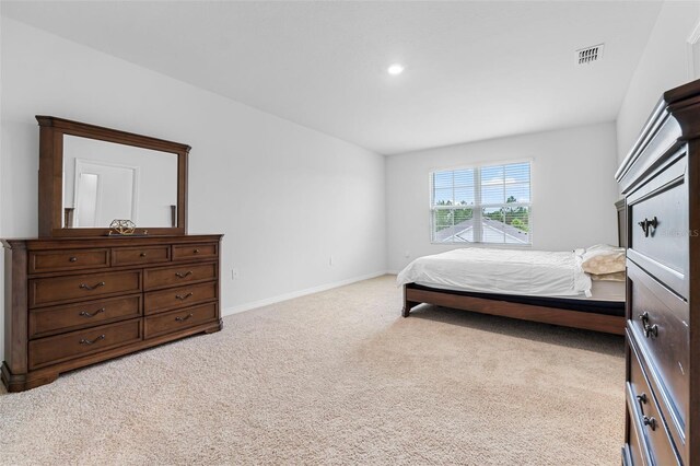 bedroom featuring light carpet