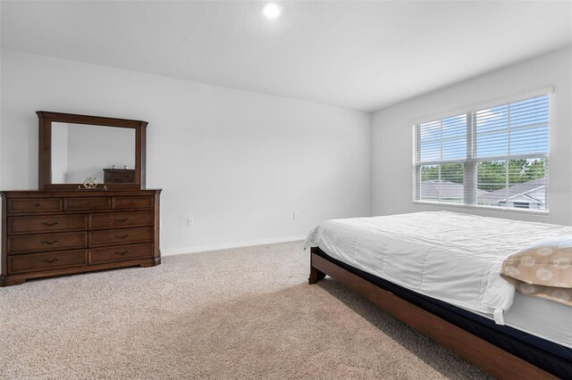 bedroom featuring light carpet