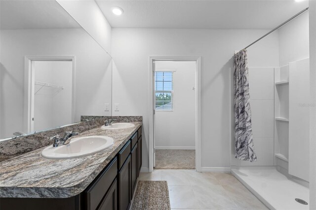 bathroom with vanity, curtained shower, and tile patterned flooring